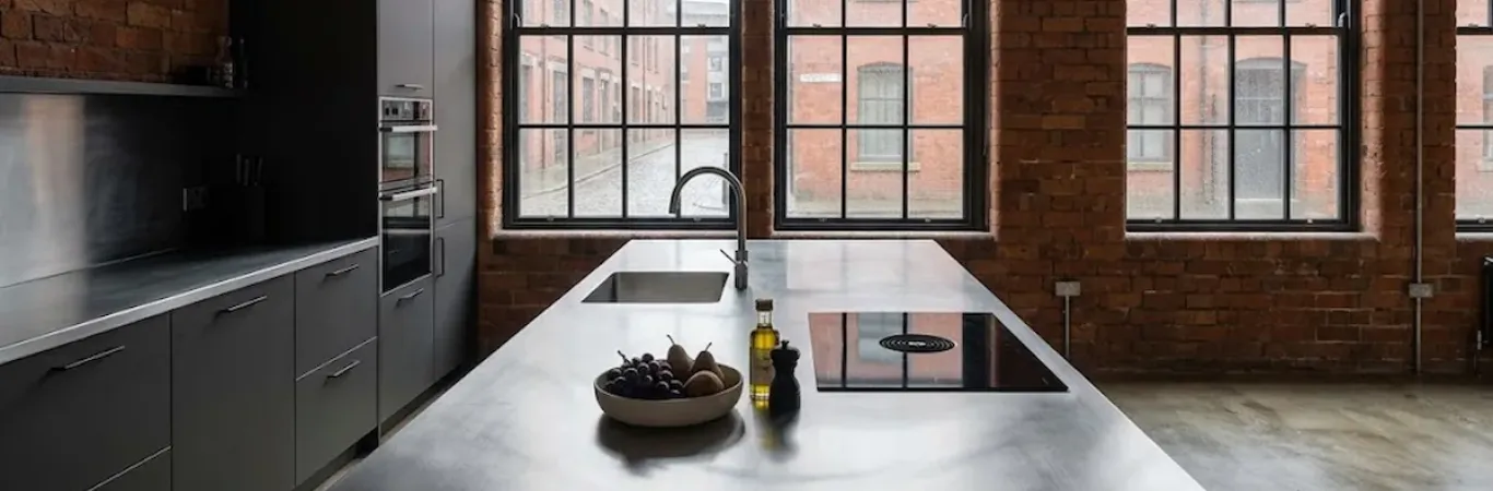 304 satin brushed stainless steel kitchen island with integrated sink and hob in an Ancoats warehouse conversion, Manchester
